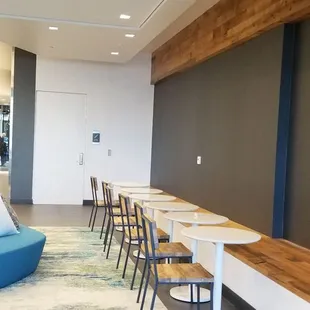 a long table with chairs and a blue couch