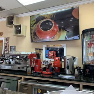 a coffee machine and coffee cups on a counter
