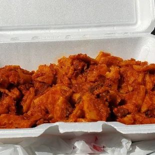 a take out container of chicken wings