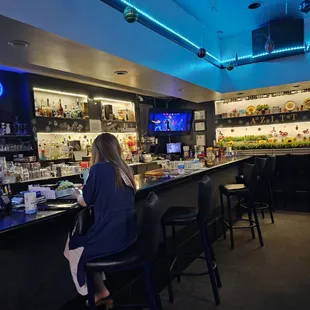 a woman sitting at a bar