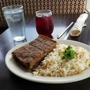 a plate of food with rice and meat
