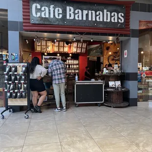 two people standing in front of a store