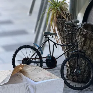 a bicycle parked on a wooden table