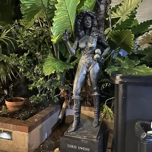 a statue of a woman sitting on a box