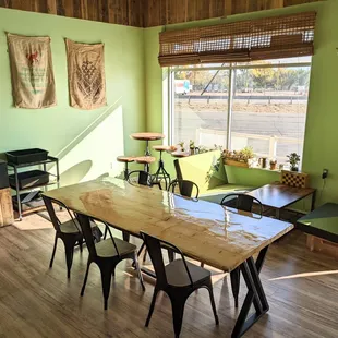a table and chairs in a green room