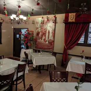 tables and chairs with white tablecloths