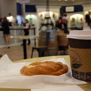 a cup of coffee and a croissant