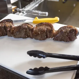 steak skewers on a cutting board