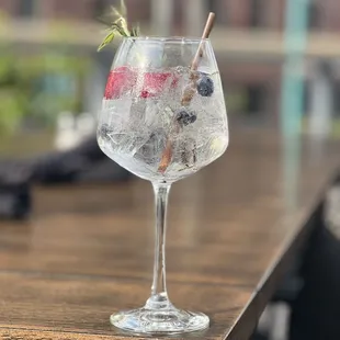 a gin glass with ice and berries