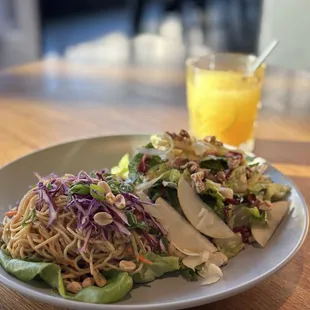 a plate of food and a glass of orange juice