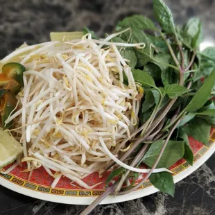 a plate of bean sprouts and lime