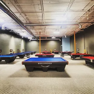 a billiards room with pool tables
