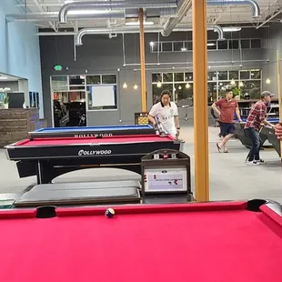 a man standing in front of a pool table