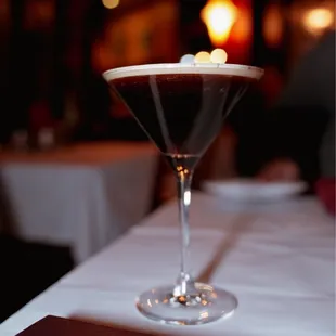 a glass of coffee on a table