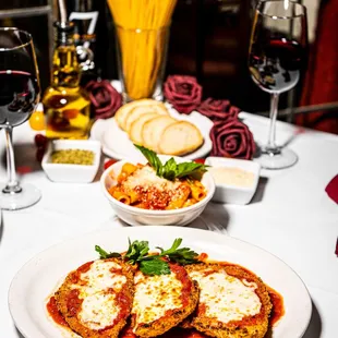 a plate of lasagna and a glass of red wine