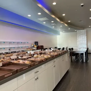 a long counter with a variety of pastries