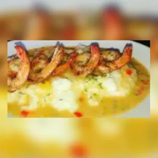 a plate of shrimp and grits