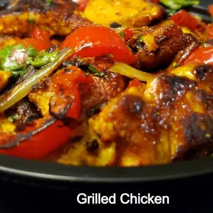 a plate of food with tofu and peppers