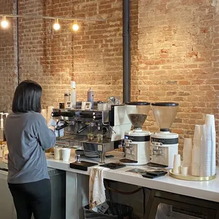 a woman working at a coffee shop