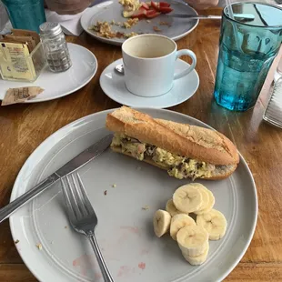 Breakfast sandwich with ham onion mushroom. Ate half and the strawberries before I took the photo.