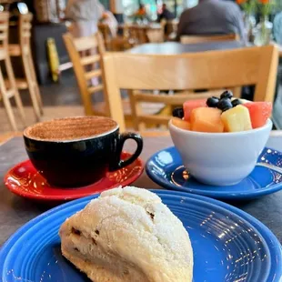 Freshly baked orange scone, Fruit cup and Cappuccino SF