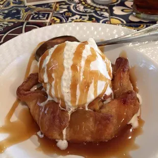 a plate of french toast with ice cream and caramel sauce