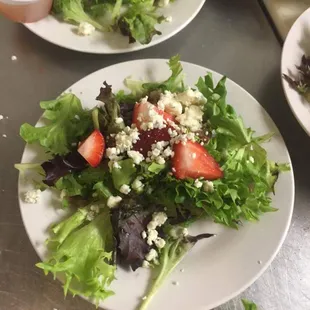 a salad with strawberries and feta cheese