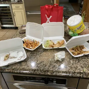 a variety of takeout containers on a kitchen counter