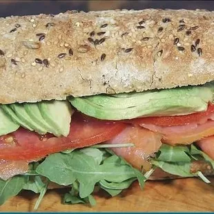 a sandwich with avocado, tomato, and lettuce