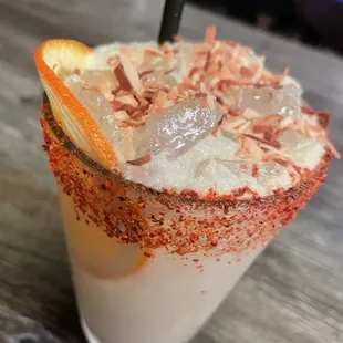 a drink with orange garnish garnish