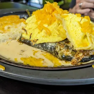 Breakfast Relleno stuffed with chorizo, spicy cream sauce topped with scrambled eggs, hash brown casserole ( OMG)