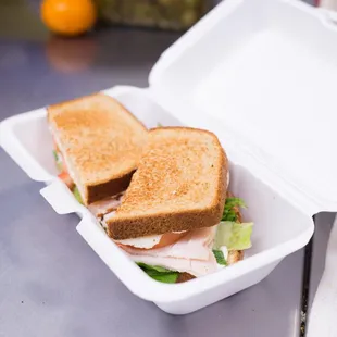 a sandwich in a styrofoam container