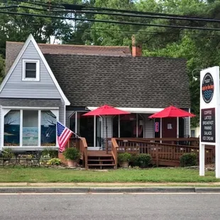 a small house with an american flag on the porch