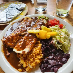 Chicken enchiladas, black beans, rice, Mayan Cole slaw topped off with guacamole, tomatoes and mangos! So goood