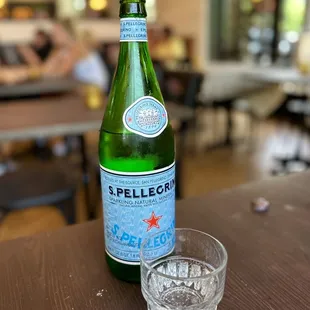 a bottle and a glass on a table