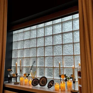 candles and dishes on a window sill