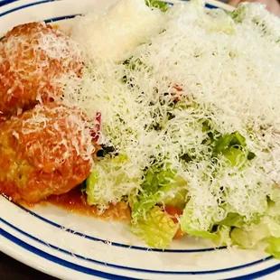 a plate of lasagna and a salad