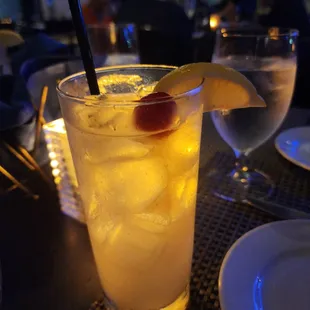 a glass of lemonade with a garnish