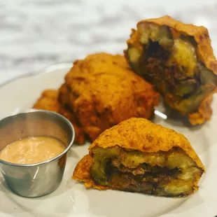 a plate of fried food with dipping sauce