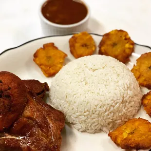 a plate of food with rice and fried tofu