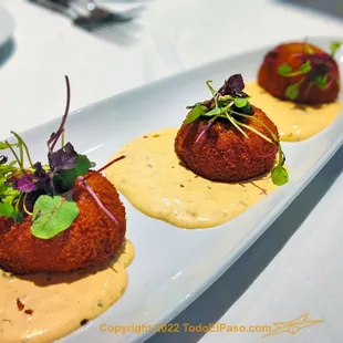 three appetizers on a white plate