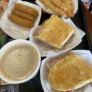 Croquetas, Cuban sandwich, cafe con leche, empanada, and deditos de guayaba y queso