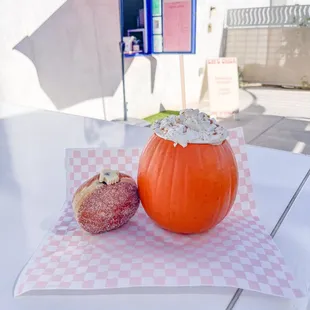 a pumpkin and a donut on a table