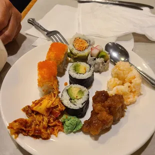 a plate of sushi and other foods