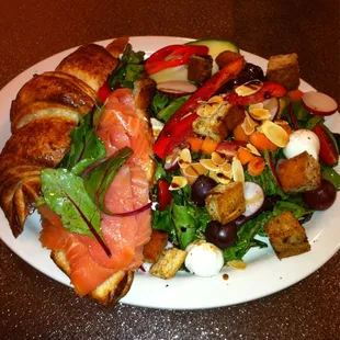 Smoked salmon on a croissant and mascarpone aioli with field greens on the side.