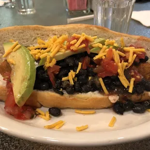 Chili vegan hot dog with avocado and vegan cheese