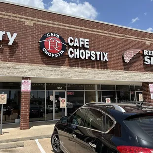 a car parked in front of a restaurant