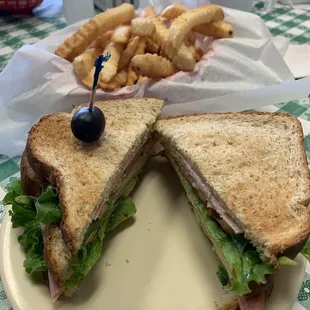 Club sandwich with fries.