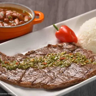 a plate of steak and rice