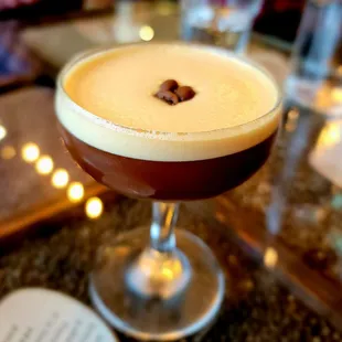 a coffee drink in a coupe glass